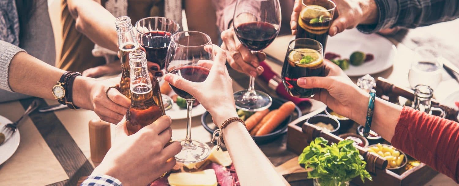 Keys being handed over with a suitcase in the background